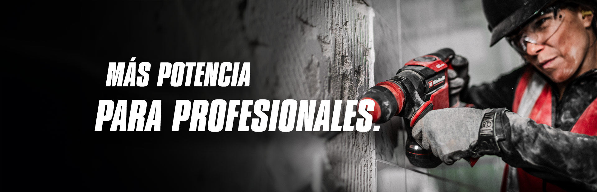 Una persona con gafas de seguridad y casco utiliza un taladro rojo en una pared, con el texto "Más potencia para profesionales".