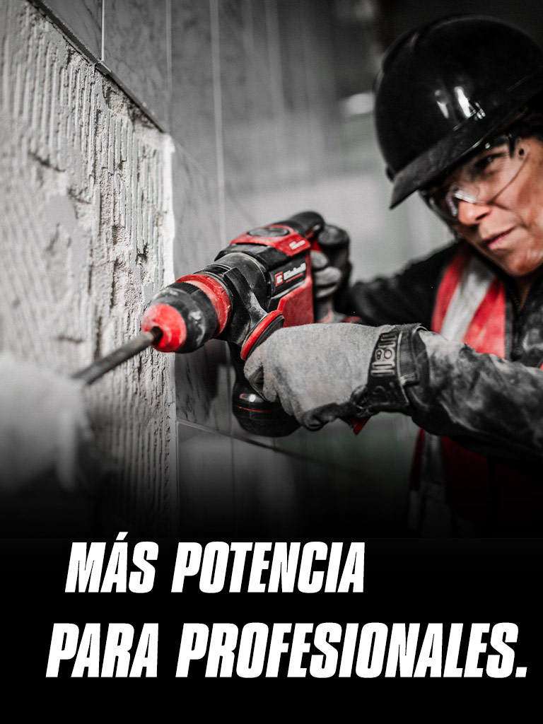 Una persona con gafas de seguridad y casco utiliza un taladro rojo en una pared, con el texto "Más potencia para profesionales".